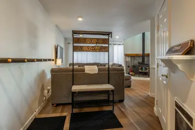 a bedroom with a bed and a chair in a room at Sierra Park Villas 17 in Mammoth Lakes