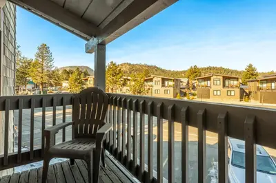 a rocking chair on a porch with a view of a street at Sierra Park Villas 17 in Mammoth Lakes