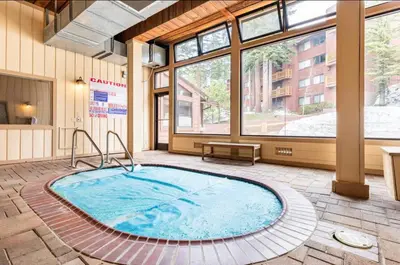 a large pool in a room with a large window at Mammoth Ski and Racquet 89 in Mammoth Lakes
