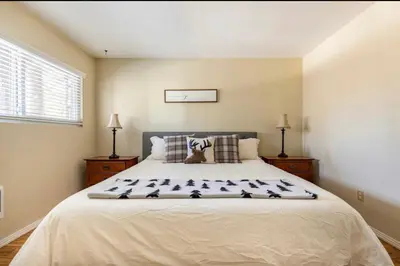 a bedroom with a large white bed with pillows at Mammoth View Villas 32 in Mammoth Lakes