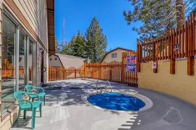 a patio with two chairs and a small pool at Mammoth View Villas 32 in Mammoth Lakes