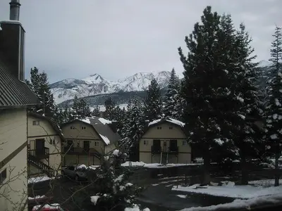 a group of houses with snow covered trees and mountains at Mammoth View Villas 32 in Mammoth Lakes