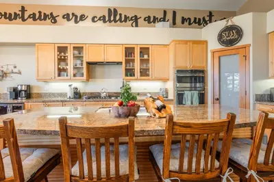 a kitchen with a large kitchen island with wooden cabinets at Snowcreek 821 in Mammoth Lakes
