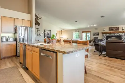 a kitchen with a counter top and a living room at Snowcreek 821 in Mammoth Lakes