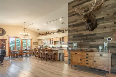 a kitchen and dining room with a reclaimed wood wall at Snowcreek 821 in Mammoth Lakes