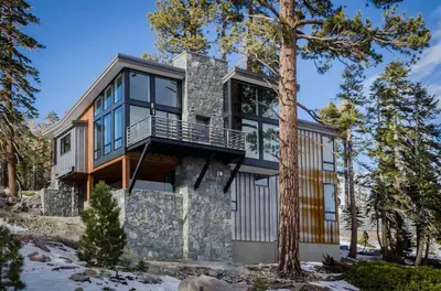 a house with a stone wall and glass at 88 Bridges Lane in Mammoth Lakes