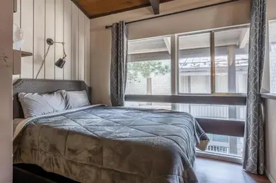 a bedroom with a bed and a large window at Sierra Park Villas 45 in Mammoth Lakes