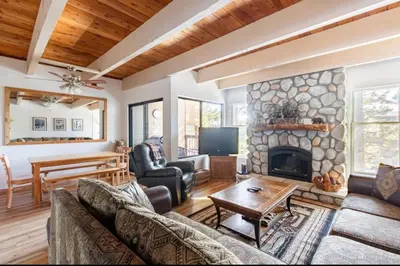 a living room with a couch and a fireplace at Val DIsere 14 in Mammoth Lakes