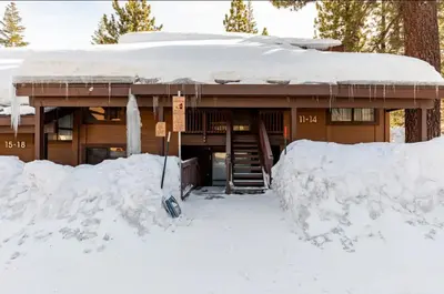 a house covered in snow with a pile of snow at Val DIsere 14 in Mammoth Lakes