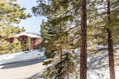 a view from the trees in front of a lodge at Val DIsere 14 in Mammoth Lakes