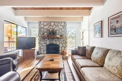 a living room with a couch and a fireplace at Val DIsere 14 in Mammoth Lakes