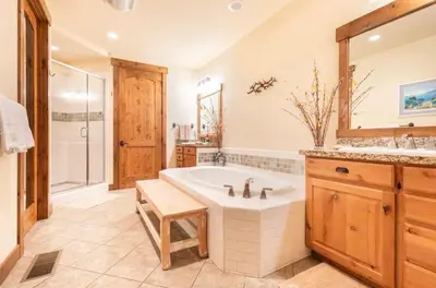 a bathroom with a tub and a shower and a sink at Lodges 1129 in Mammoth Lakes