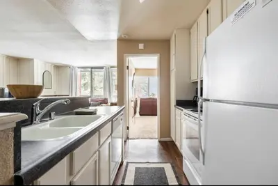 a kitchen with a sink and a refrigerator at Crestview 45 in Mammoth Lakes