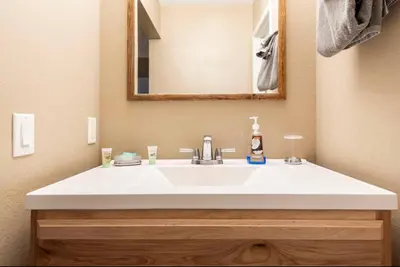 a bathroom with a white sink and a mirror at Crestview 45 in Mammoth Lakes