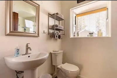 a bathroom with a sink and a toilet and a mirror at Forest Creek 21 in Mammoth Lakes