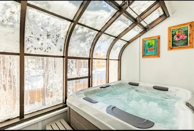 a hot tub in a room with a large window at Forest Creek 21 in Mammoth Lakes