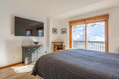 a bedroom with a bed and a large window at Snowcreek 778 in Mammoth Lakes