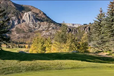a golf course with a mountain in the background at Snowcreek 778 in Mammoth Lakes