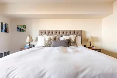 a bedroom with a large white bed with pillows at Bridges 210 in Mammoth Lakes