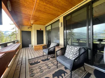 a screened porch with two chairs and a piano at Bridges 210 in Mammoth Lakes