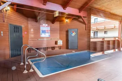 a pool in the middle of a building with a table at Bridges 210 in Mammoth Lakes
