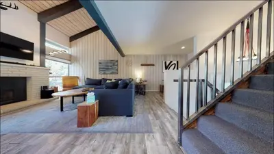 a living room with a blue couch and a fireplace at Chamonix 91 in Mammoth Lakes