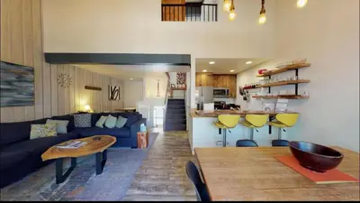 a living room with a blue couch and a table at Chamonix 91 in Mammoth Lakes