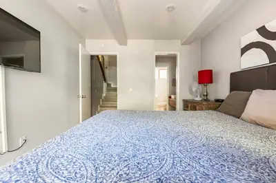 a bedroom with a large bed with a blue blanket at Chamonix 91 in Mammoth Lakes