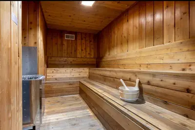 an empty wooden sauna with a bucket in it at Chamonix 91 in Mammoth Lakes