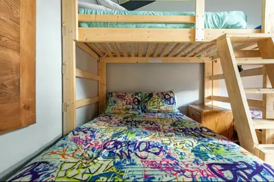 a bedroom with a bed and a bunk bed at Chamonix 91 in Mammoth Lakes
