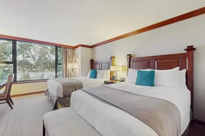 a hotel room with two beds and a window at Everline Resort & Spa 536 in Olympic Valley