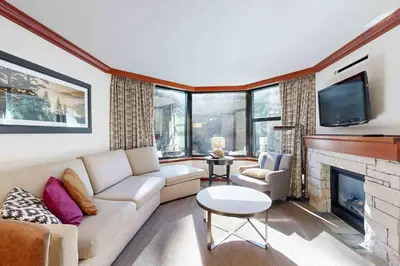 a living room with a couch and a fireplace at Everline Resort & Spa 534 in Olympic Valley