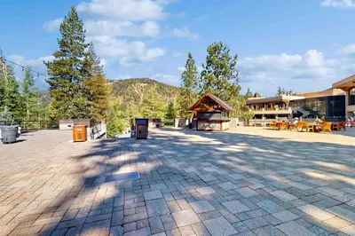 an empty parking lot with a building and trees at Everline Resort & Spa 534 in Olympic Valley