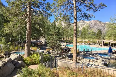 a swimming pool in a resort with trees at Everline Resort & Spa 534 in Olympic Valley