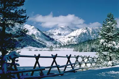 a fence in the snow with mountains in the background at Everline Resort & Spa 534 in Olympic Valley
