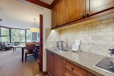 a kitchen with a sink and a living room at Everline Resort & Spa 534 & 536 in Olympic Valley