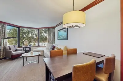 a living room with a table and chairs and a couch at Everline Resort & Spa 534 & 536 in Olympic Valley