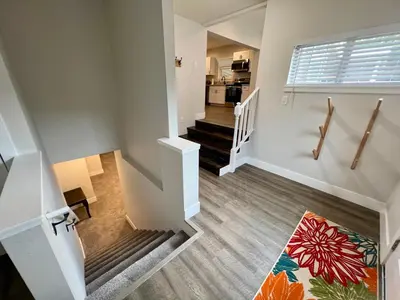 an empty room with a staircase and a kitchen at 717 Charming 4 Bed Mid-Town Retreat in Reno