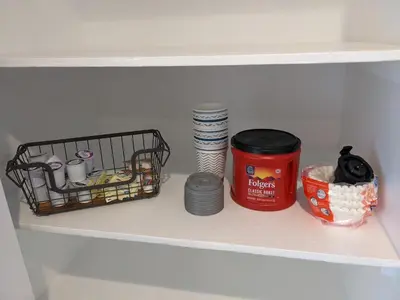 a shelf in a refrigerator with dishes and a can and plates at 717 Charming 4 Bed Mid-Town Retreat in Reno