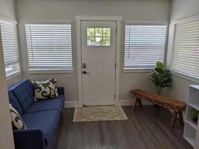 a living room with a blue couch and a door at 717 Charming 4 Bed Mid-Town Retreat in Reno