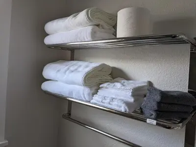 a pile of towels on a towel rack in a bathroom at 717 Charming 4 Bed Mid-Town Retreat in Reno