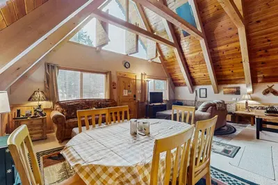 a dining room with a table and chairs at Cabin on Ralph in South Lake Tahoe