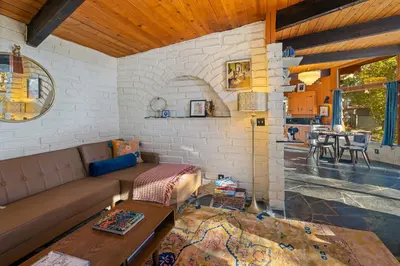 a living room with a couch and a table at 16 mi to Yosemite-1 mi to Oakhurst-Anthro Decor in Oakhurst