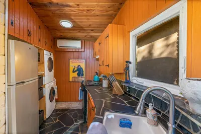 a kitchen with a sink and a refrigerator at 16 mi to Yosemite-1 mi to Oakhurst-Anthro Decor in Oakhurst