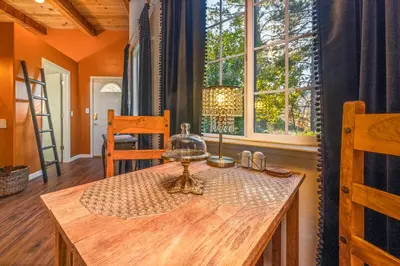 a dining room with a table and a window at 16 mi to Yosemite - Rustic Studio - Hiking Nearby in Oakhurst