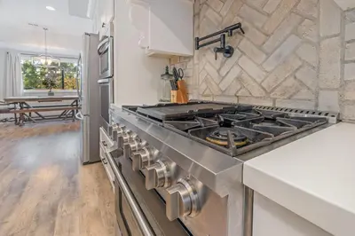 a kitchen with a stainless steel stove top oven at Lake View Private Dock 18 miles to Yosemite in Bass Lake