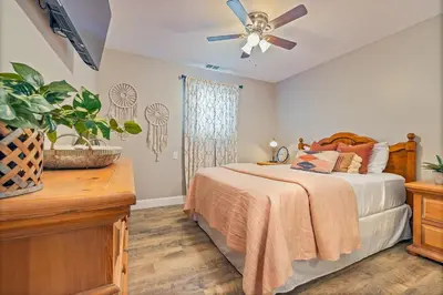 a bedroom with a bed and a ceiling fan at Lake View Private Dock 18 miles to Yosemite in Bass Lake
