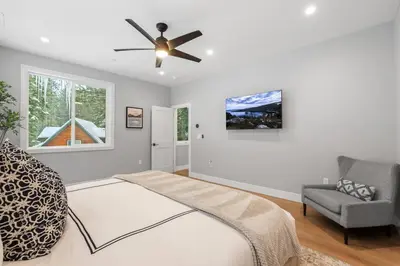 a bedroom with a bed and a ceiling fan at Tahoe Toasty - 3 Bedroom Home Near Sledding Hill in South Lake Tahoe