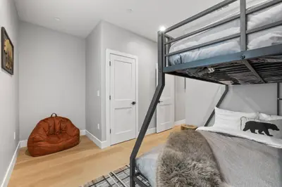a bedroom with a bunk bed with a bear pillow at Tahoe Toasty - 3 Bedroom Home Near Sledding Hill in South Lake Tahoe