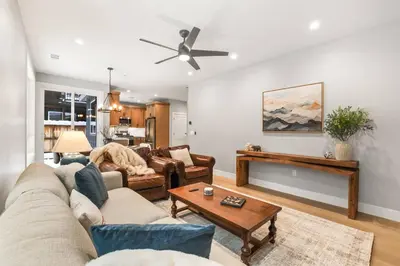 a living room with a couch and a table at Tahoe Toasty - 3 Bedroom Home Near Sledding Hill in South Lake Tahoe